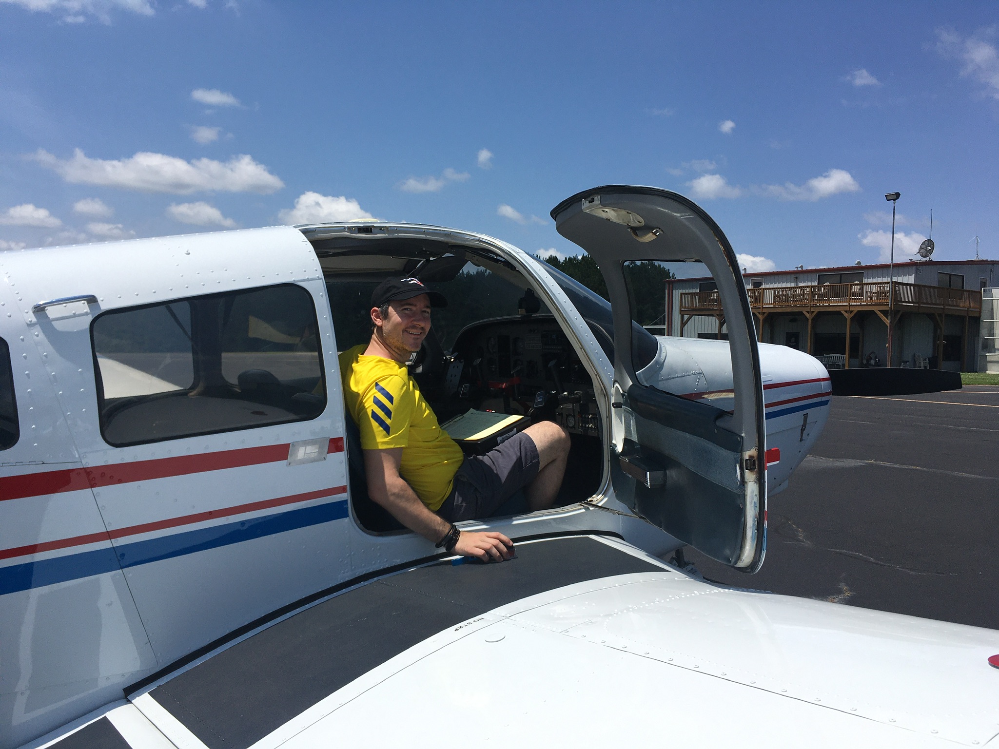 Tyrel sitting in passenger seat, waiting for Lauren to get into plane.