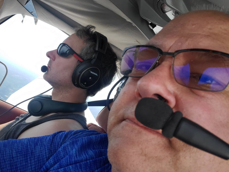 Inside the cockpit, profile view of me, and part of my father's head.