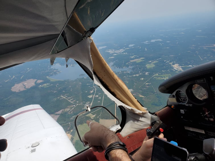 Me pointing out the tiny window on the airplane.